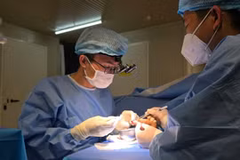 Vietnamese surgeons working on the injured finger. (Photo courtesy of FHL 2.6.) 