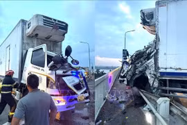 Firefighters and rescue personnel deploy specialised equipment to rescue two truck drivers trapped in their cabins. (Photo: VNA) 