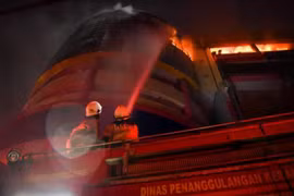 Firefighters trying to extinguish the blaze that engulfed the upper storey of Glodok Plaza in Taman Sari, West Jakarta, Indonesia on Jan 15, 2025. (Photo: Antara) 