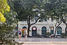 International visitors stroll beneath the leafy trees along Hoan Kiem Lake, enjoying Hanoi’s cool autumn weather. (Photo: VNA)