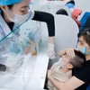 Collecting a sample from a pediatric patient for influenza testing (Photo: VNA)