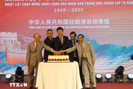 Officials cut the cake to celebrate the 76th anniversary of China’s National Day at the ceremony on September 23. (Photo: VNA)