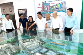 Businessman Nguyen Hoai Bac (third from right) introduces visitors to the model of Dai Son urban area, of which he is the investor. (Photo published by VNA)