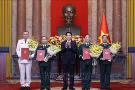 State President Luong Cuong (centre) and the newly promoted officers at the ceremony. (Photo: VNA)