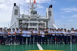 Representatives of the Vietnam Coast Guard and the Malaysia Maritime Enforcement Agency (MMEA) in Pahang pose for a photo on the deck of CSB 8005. (Photo: VNA)
