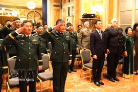 Delegates attending the opening ceremony of the Vietnamese Defense Attaché Office in Italy participate in the flag salute ceremony. (Photo: VNA)