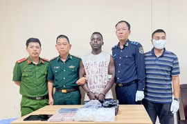 A Nigerian national (centre) is arrested for suspected connection with a major drug trafficking case from Laos into Vietnam. (Photo published by VNA)