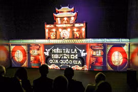 Viewers watch Thang Long Capital show featuring 3D mapping and digital experiential spaces. (Photo: VNA)