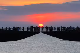 Tourists watch the sunset from the Kiss Bridge in Phu Quoc special zone, An Giang province. (Photo published by VNA)