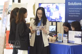 Technologies for developing digital government infrastructure and cashless payment solutions are showcased at an exhibition. (Photo: VNA)
