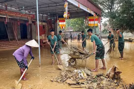 Officers and soldiers help people clean up and overcome flood consequences in Tam Giang commune of Bac Ninh province. (Photo: VNA)