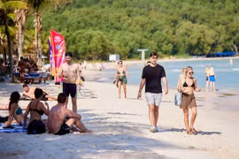 International visitors stroll along Kem Beach in southern Phu Quoc, one of the world's most beautiful beaches. (Photo: Sun Group)