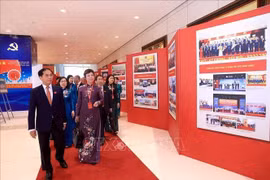 Deputy Prime Minister Bui Thanh Son and delegates visit the photo exhibition within the first Congress of the Government's Party Organisation on October 12. (Photo: VNA)