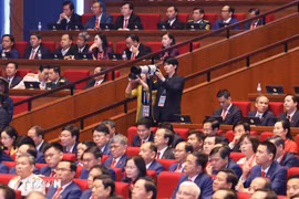 Vietnam News Agency reporters cover the 14th National Party Congress. (Photo: VNA) 