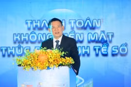 Deputy Prime Minister Ho Duc Phoc speaks on Saturday at a seminar held as part of the annual Cashless Day 2025 event in HCM City (Photo: VNA)