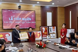 Director of Ho Chi Minh Museum Vu Manh Ha receives documents and artifacts from the family representative of former Deputy Prime Minister Dang Viet Chau. (Photo: VNA)
