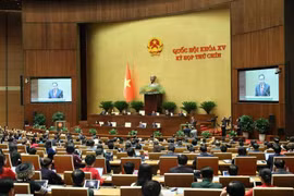 Lawmakers scrutinise a draft resolution on supplements and amendments to several articles of the 2013 Constitution. (Photo: VNA)