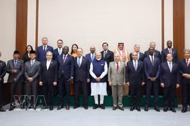 Ministers and deputy ministers from BRICS member and partner countries pose for a group photo while attending the Expanded BRICS Foreign Ministers' Meeting in India on May 14. (Photo: VNA)