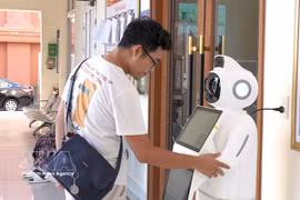 AI-powered robots help ease the workload of civil servants in providing initial consultations, while enabling citizens to become familiar with AI applications in accessing public services. (Photo: VNA)