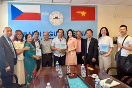 Nguyen Quyet Tien (sixth from left), an engineer and translator, donates a set of Vietnamese-Czech-English dictionaries to the Vietnamese language centre. (Photo: VNA)