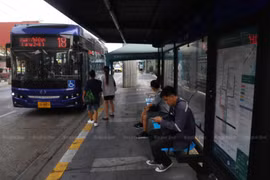 People wait for a bus at a bus stop in Bang Phlat district of Bangkok. (Photo: Bangkok Post/Nutthawat Wichieanbut)