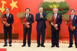 Party General Secretary To Lam presents the Military Exploit Order to the high-ranking officials on March 30. (Photo: VNA)