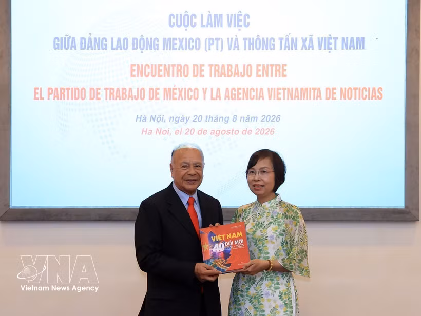 VNA General Director Vu Viet Trang (R) presents a pictorial book to PT General Secretary Alberto Anaya Gutiérrez at the meeting on August 20. (Photo: VNA)