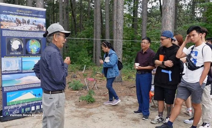 Dr. Dang Trung Phuoc (left) is introducing the history and origin of the Pinhey sand dunes (Photo: VNA)