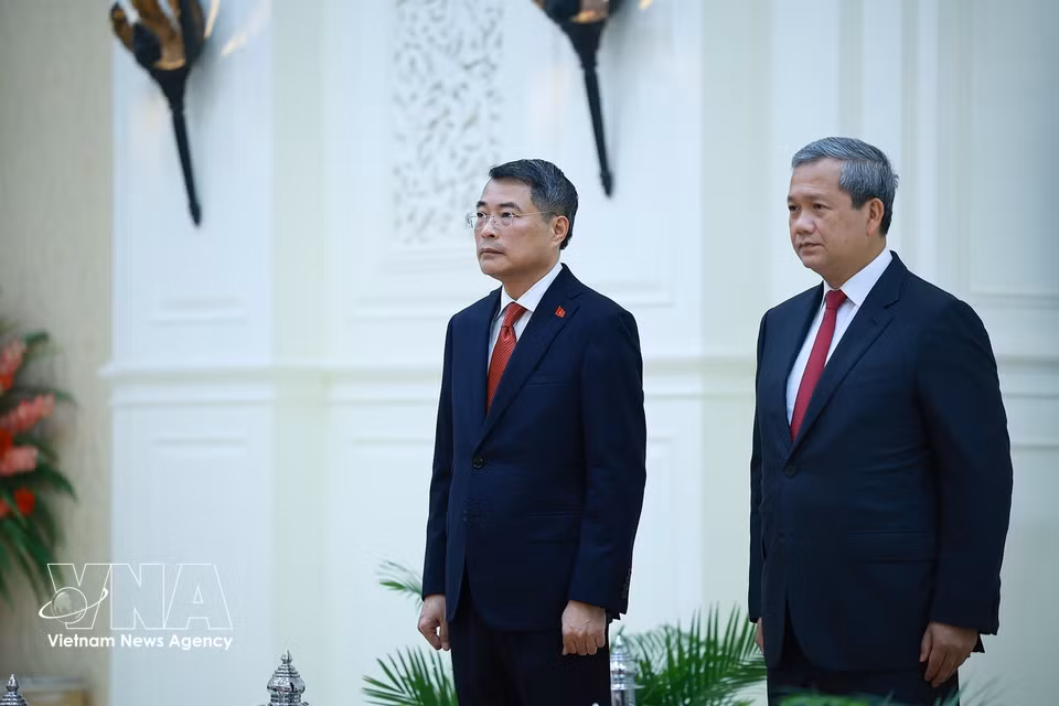 Prime Minister Le Minh Hung and his Cambodian counterpart Hun Manet listen as a military band plays the national anthems of the two countries. (Photo: Duong Giang/VNA)