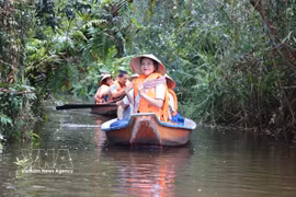 Tourists enjoy a boat ride while exploring the Dong Thap Muoi Ecological Reserve in Tan Phuoc 2 commune, Dong Thap province. (Photo: VNA)