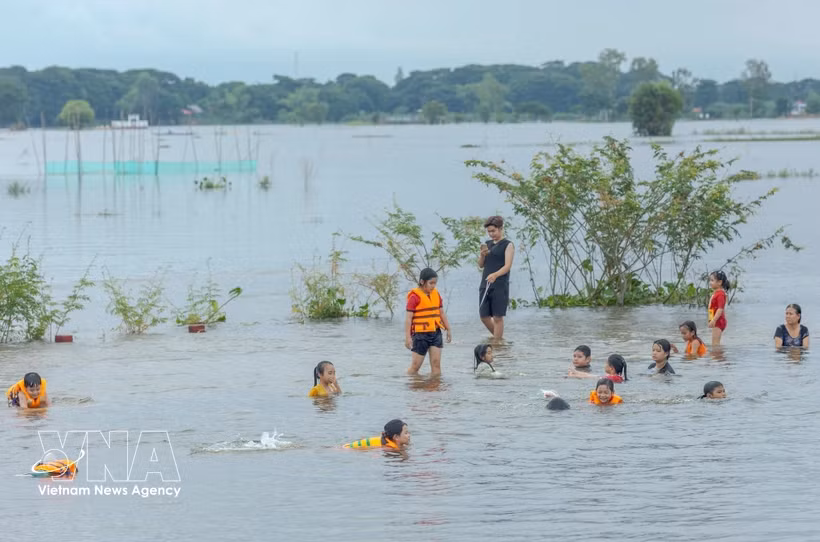 Local residents enjoy bathing in flooded fields during the flood season in the Cong Bung Ren area, Vinh Loi hamlet, Phu Huu commune, An Giang province (Photo: VNA)