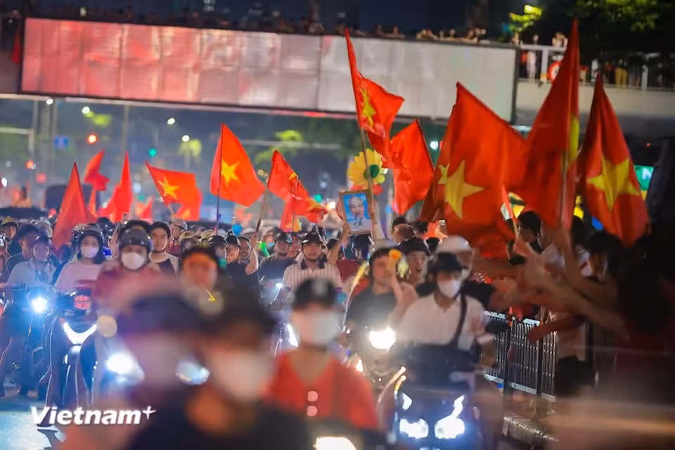 Traffic inches forward metre by metre, but there is no anger over the congestion. Strangers united by their love of football trade high-fives and congratulations instead. (Photo: VietnamPlus)