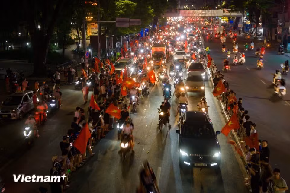 Streams of revellers and vehicles pour through the streets without letup, with the red of the national flag, T-shirts and banners filling the cityscape. (Photo: VietnamPlus)