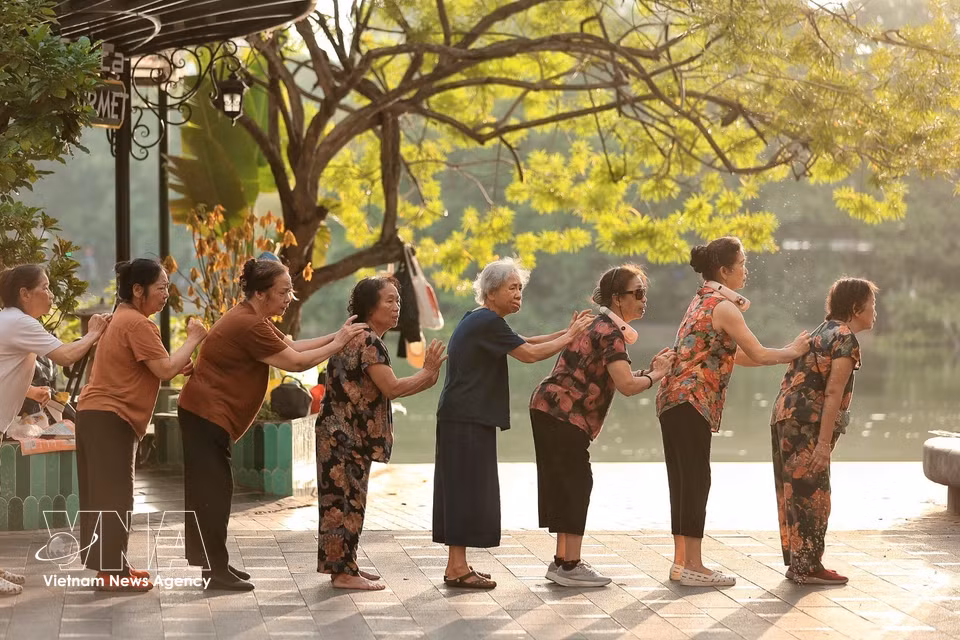 A group of older women perform exercises together. (Photo: Pham Tuan Anh/VNA)
