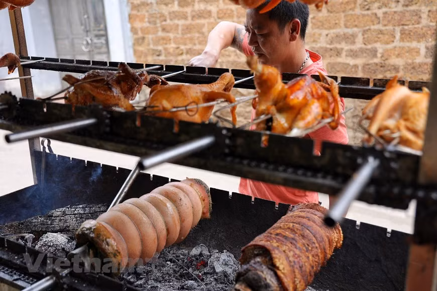 It would be great regret if visitors to Duong Lam skip the local roasted pork and honey-glazed roasted chicken, which are also renowned dishes of this village. The roasted pork, traditionally on bamboo poles, has tender and juicy meat, along with incredibly brown crispy skin. Legend has it that when Ngo Quyen (897 - 944) defeated the Southern Han enemy on the Bach Dang River, the pork roasted on bamboo sticks was the dish made to give a feast to his troops. Today, this recipe is still considered a special treat that people of Duong Lam village use to welcome their friends and tourists. (Photo: VietnamPlus)