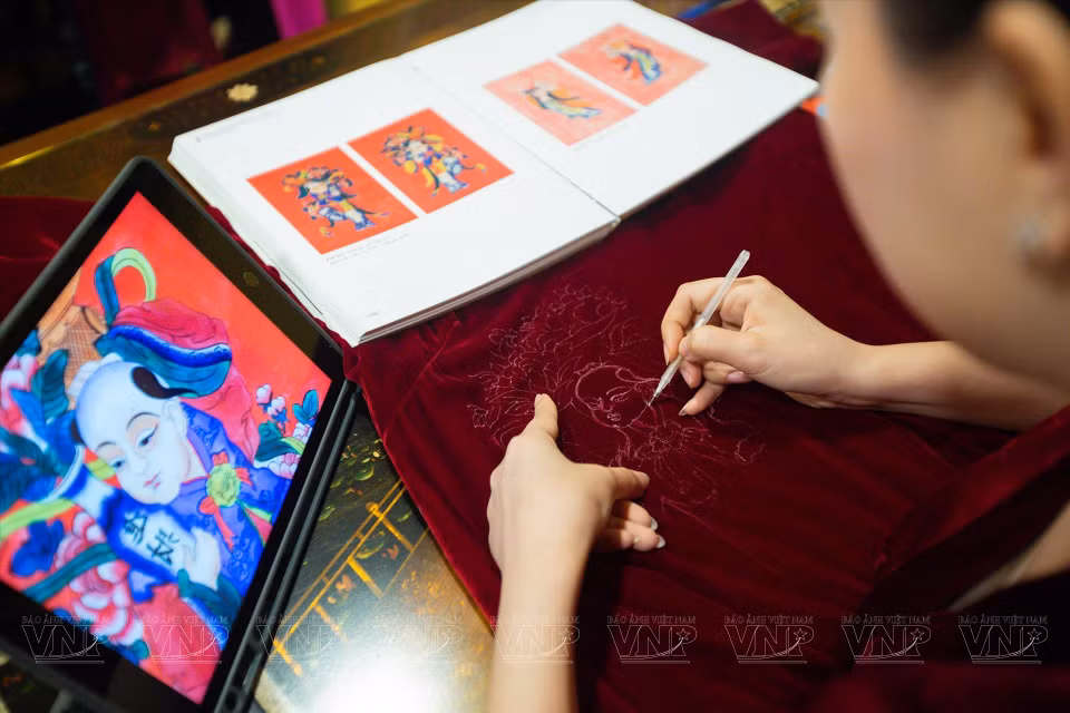 Designer Nguyen Tho Tho with her fashion collection of Dong Ho paintings. (Photo: VNA)