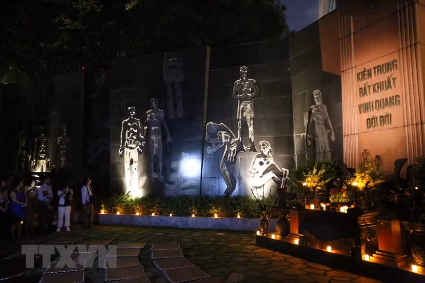 The journey backwards in time takes visitors through the main gate to dark cells, a tropical almond tree, a guillotine, a monument, and blocks for male prisoners, female prisoners, and political prisoners (Photo: VNA)