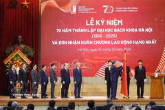 Party General Secretary and President To Lam presents the First-Class Labour Order to Hanoi University of Science and Technology. Photo: VNA