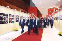 Permanent member of the Party Central Committee’s Secretariat Tran Cam Tu (front, centre) and other officials examine an exhibition of publications serving the 14th National Party Congress on January 13. (Photo: VNA)