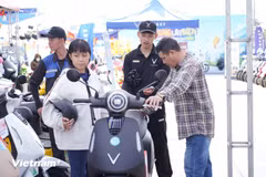 Consumers test an e-motorcycle of VinFast. (Photo: VNA)