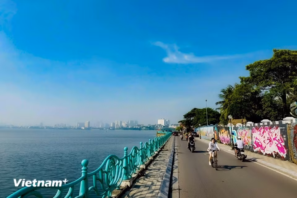 Cyclists and walkers around the lake experience its beauty and the sense of attachment felt along its winding lakeside roads. (Photo: Vietnam+)