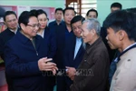 PM Pham MinhChinh visits the family of Tran Trung Kien in Duc Chanh commune, Mo Duc district, who have received financial support from the Government, along with assistance from socio-political organisations to renovate their home. (Photo: VNA)