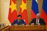 Deputy Prime Minister Tran Hong Ha (L) and his Russian counterpart Dmitry Chernyshenko sign the meeting's minute (Photo: VNA)