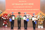 Authorised by the President, Minister of Public Security Sen. Lieut. Gen. Luong Tam Quang presents the decisions to the three officers (Photo: VNA)