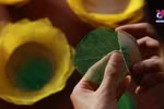 Young man gives new life to fallen leaves