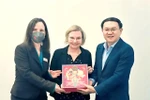 Director of the Department of Information and Communications of HCM City, Lam Dinh Thang (right), presents a souvenir to Claudia Kaiser, Vice President of the Frankfurter Buchmesse (centre), at the Frankfurt Book Fair 2023. (Photo courtesy of the Department of Information and Communications) 