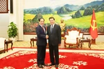 Party General Secretary and President of Laos Thongloun Sisoulith receives Deputy Prime Minister and Foreign Minister Bui Thanh Son (left) on December 17. (Photo: VNA)