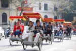 Tourists take a street tour on pedicabs in Hanoi. (Photo: VNA)