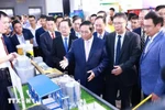 Prime Minister Pham Minh Chinh visits the display of science and technology applied products (Photo: VNA)