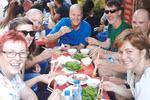 Tourists enjoy nem (deep fried spring rolls) at a street food stall in the Old Quarter. (Photo courtesy of Hanoi Street Food Tour)